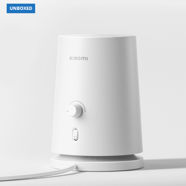 White cylindrical device with Xiaomi logo on a light gray background