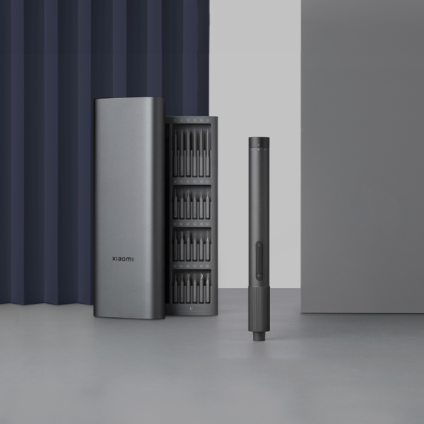 Set of Xiaomi screwdrivers and holder on a gray surface with a neutral background