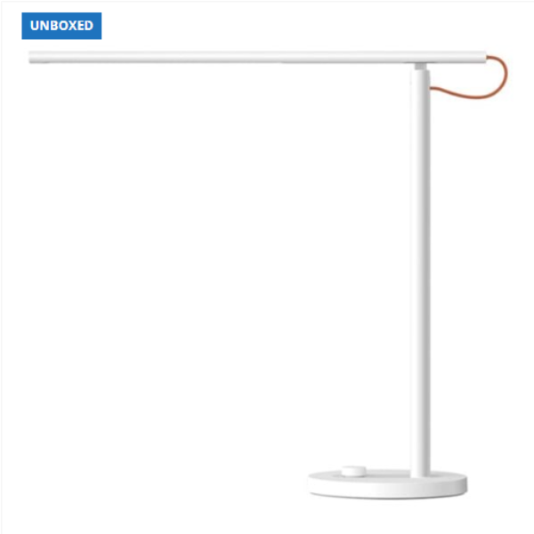 White desk lamp with a red cable on a white background, branded 'UNBOXED'.