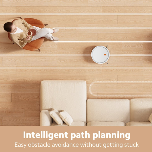 Robotic vacuum cleaner on a wooden floor with a person sitting on a chair, highlighting intelligent path planning.