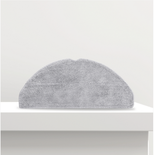 Gray semi-circular cushion on a white surface with a white background