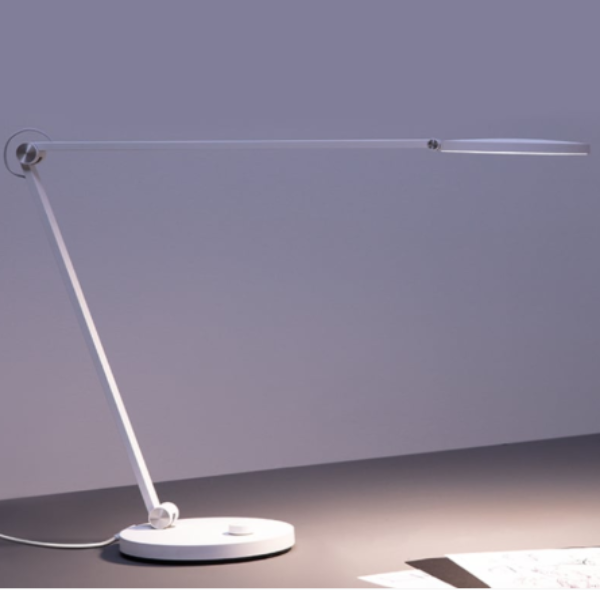 Modern desk lamp with a white base on a neutral background