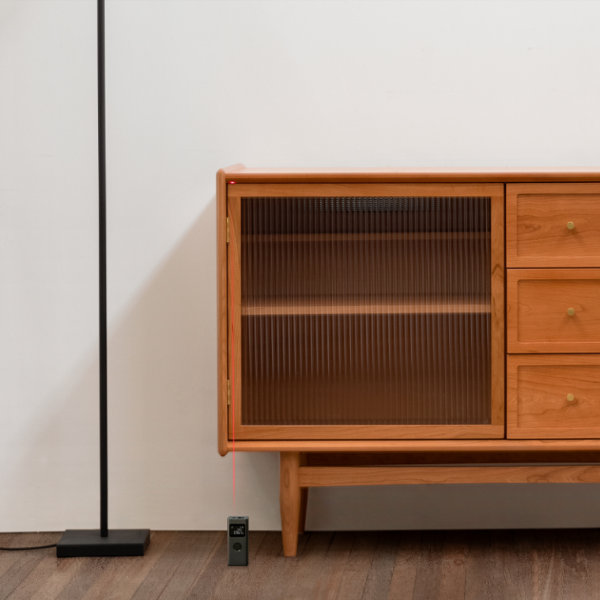 Wooden cabinet with glass door against a white wall