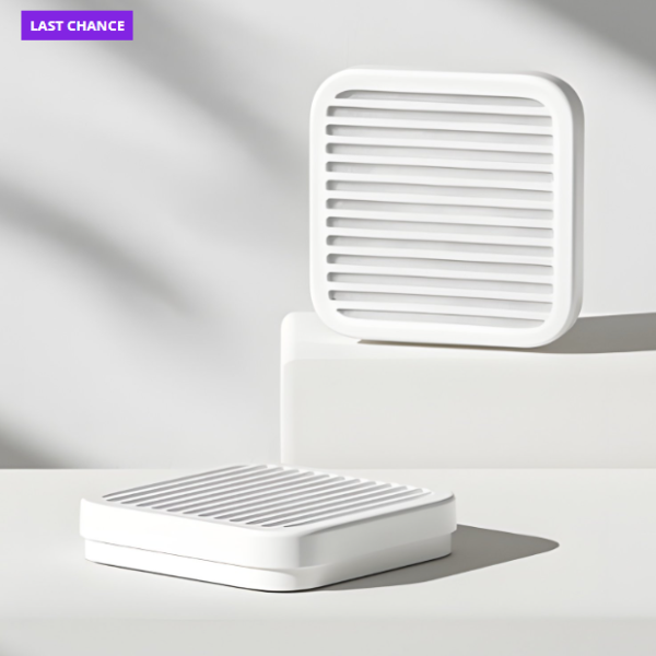 White rectangular object with slotted design on a light gray background