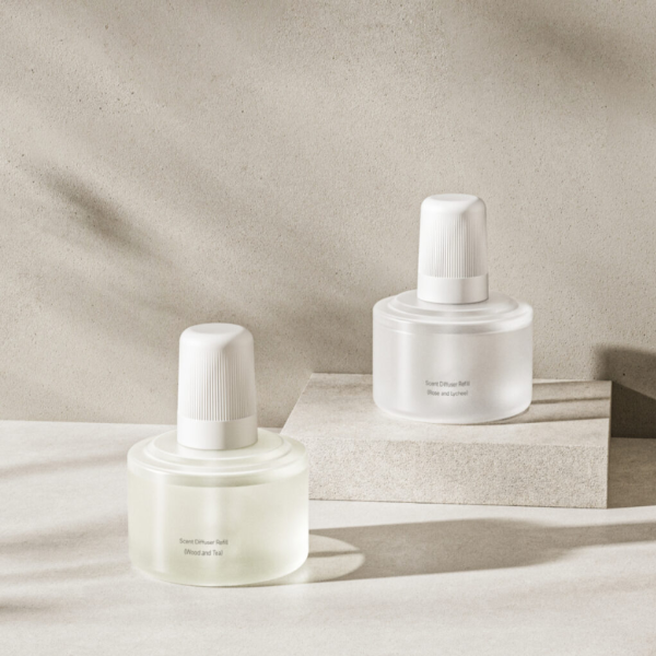 Two skincare bottles on a neutral background