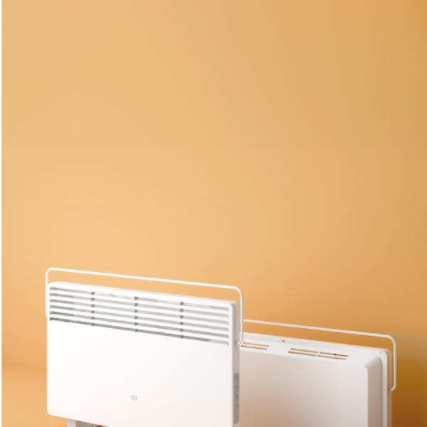 Two white electric heaters against a beige wall