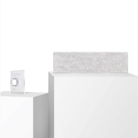 White electronic device with a textured gray top on a white background