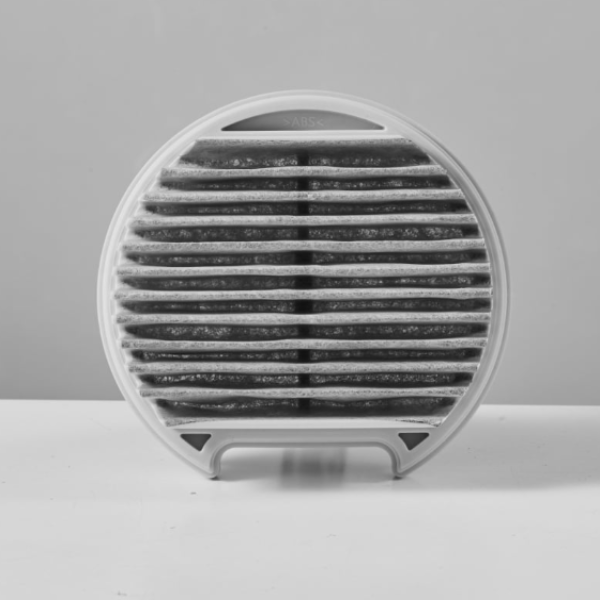 Round air filter with black pleated media on a gray background