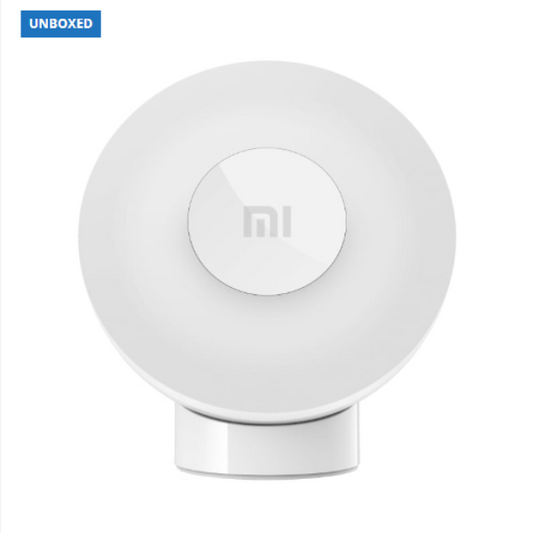 White round device with a logo on a white background, branded 'UNBOXED'.
