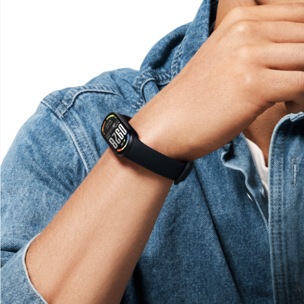 Person wearing a black smartwatch on a white background